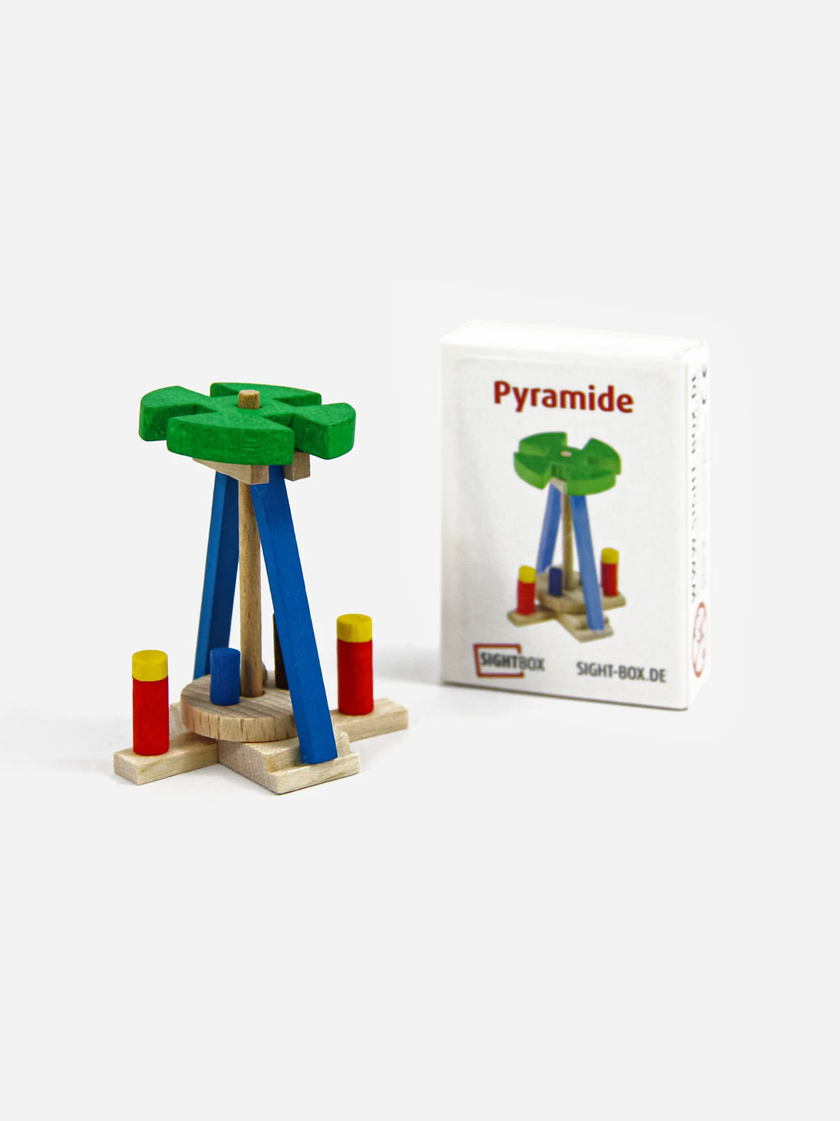 Holzbausatz Weihnachtspyramide mit grünem Flügelrad und blauen Streben neben der Sightbox-Schachtel „Pyramide“