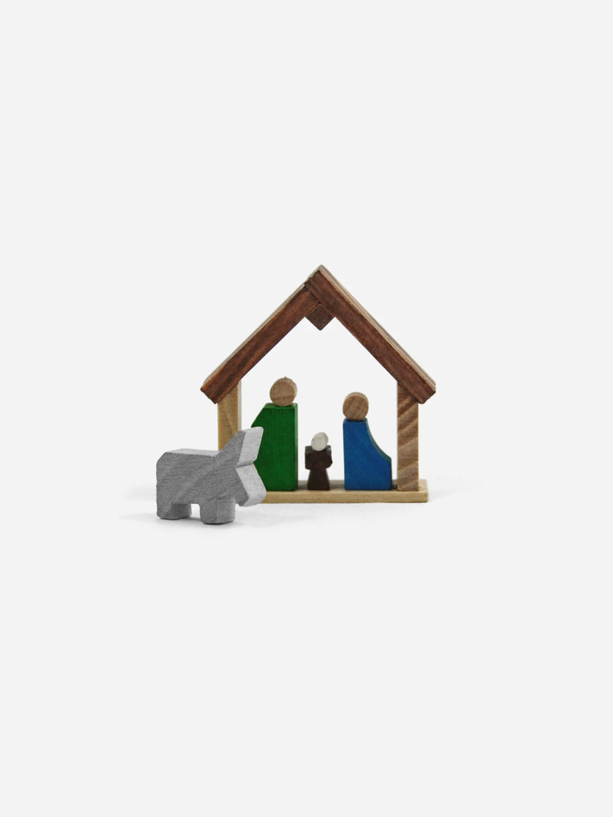 Aufgebaute Mini-Krippe aus Holz: Maria, Josef und Jesuskind im Stall, daneben ein grauer Esel